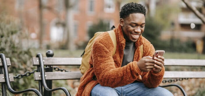 Man smiling while texting.