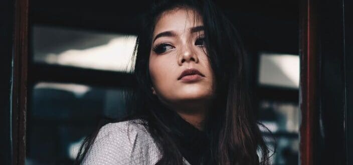 Young girl looking fiercely outside