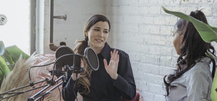 Woman being interviewed by a female host.