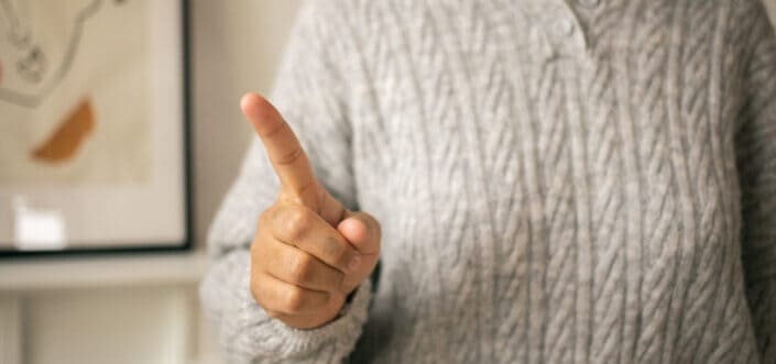 Woman gesturing a warning.