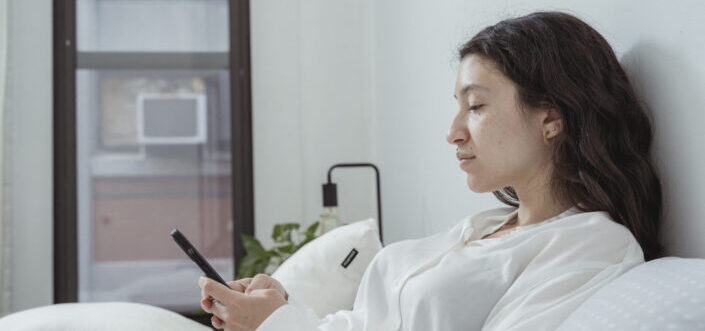 Woman seriously typing a message on her phone.