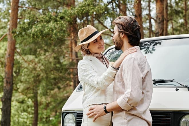 A Couple Standing Beside a Parked Car while Looking at Each Other - Sweet words for him