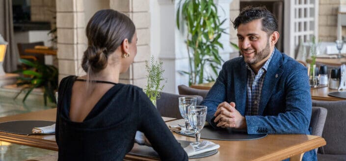 Man And Woman Sitting In A Restaurant