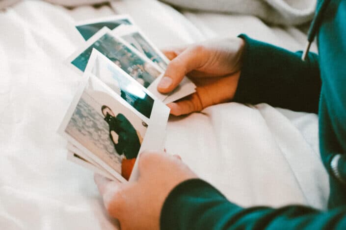 Person Looking At Instax Photographs