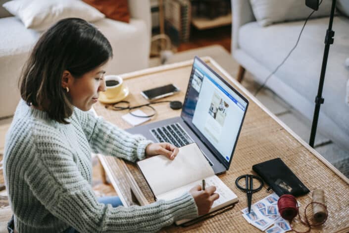 Woman Working And Writing On Her Notebook