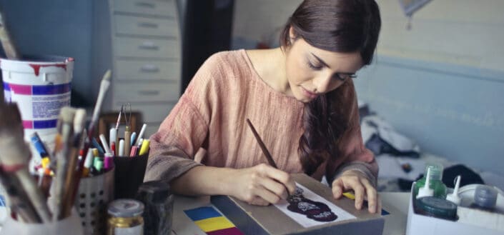 Woman making a small painting
