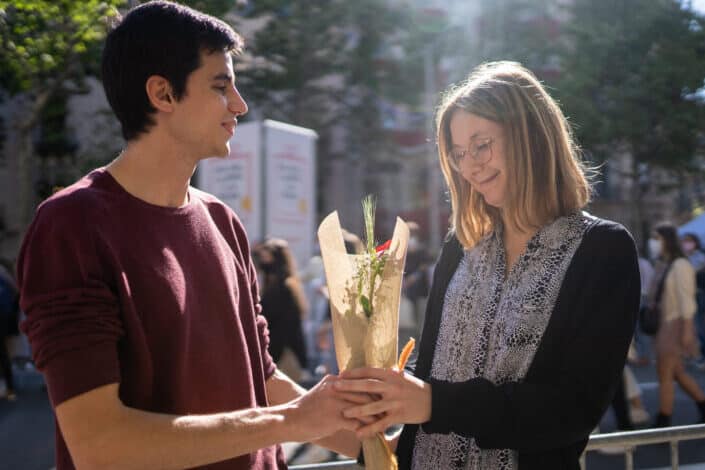 Man giving an older lady a bunch of flowers
