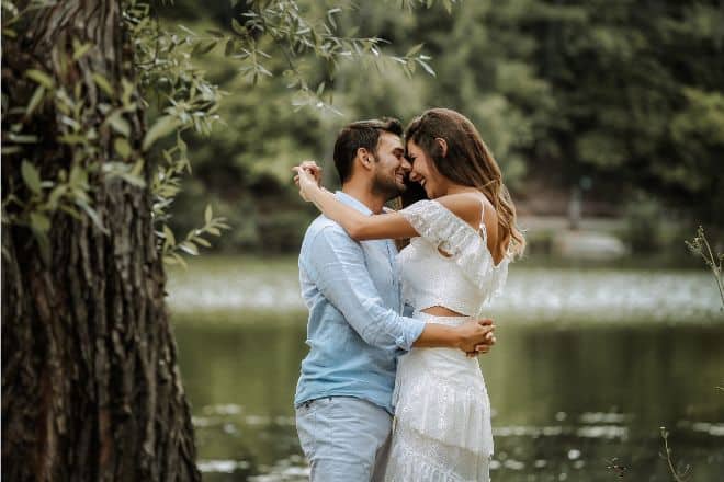  Sweet couple having some moments under a huge tree beside a river- 36 questions to fall in love - Main