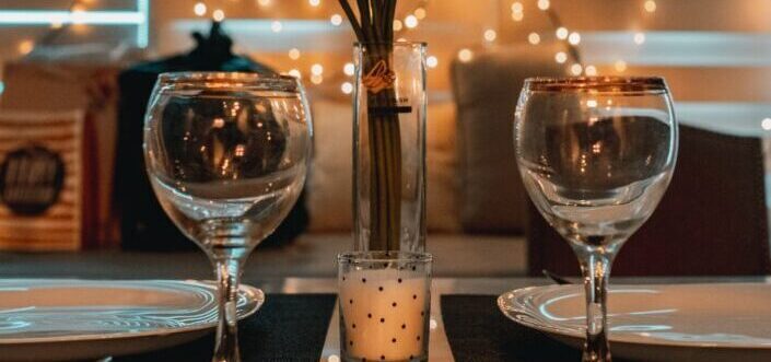two wine glasses on top of table