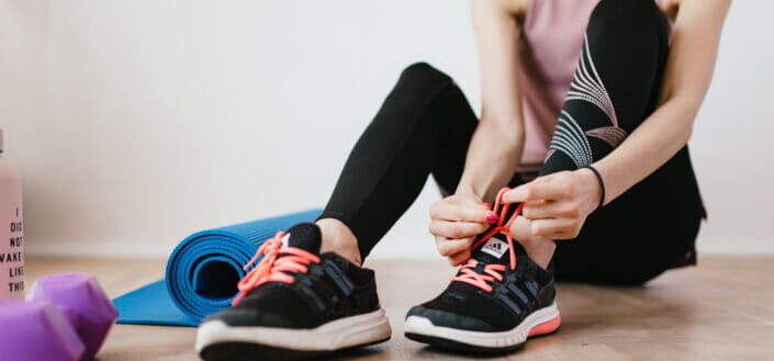 Woman Putting on Rubber Shoes