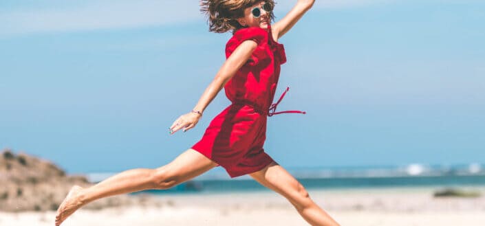 Woman Having Fun On The Beach