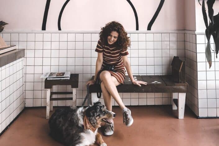 Woman Taking Her Dog Out on a Leash