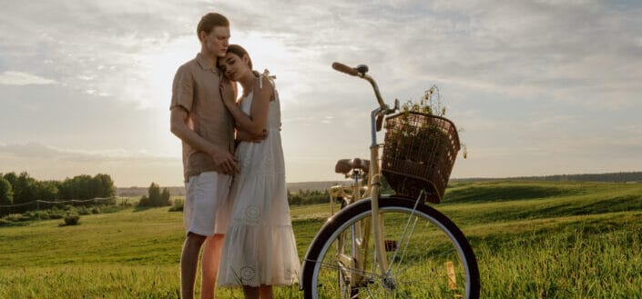 Woman Leaning on Man at Grass Field