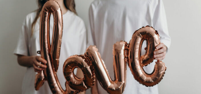 Couple Holding a Love Balloon
