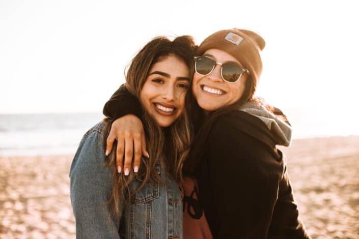 Two girls standing close to each other posing for a photo