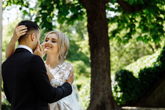 Newly Wed Couple Standing Under Tree
