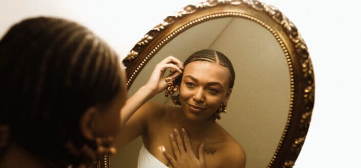 Woman Fixing Herself in the Mirror