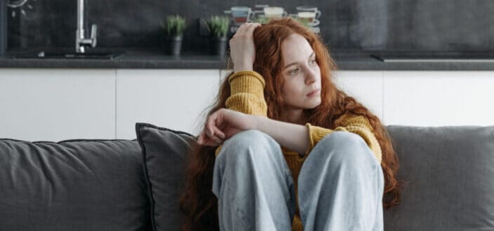 Curly Haired Woman Looking Out Her Window