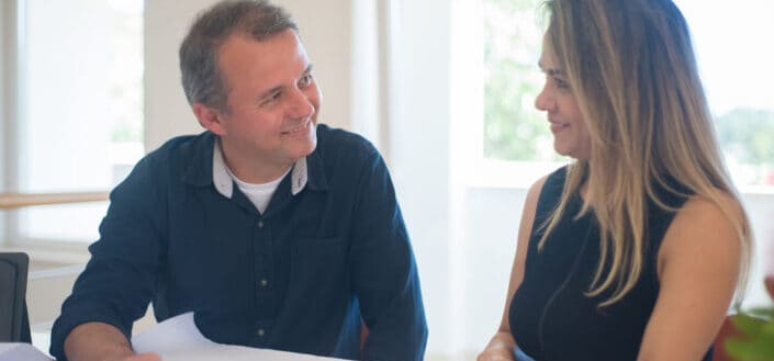 A couple looking at house plans