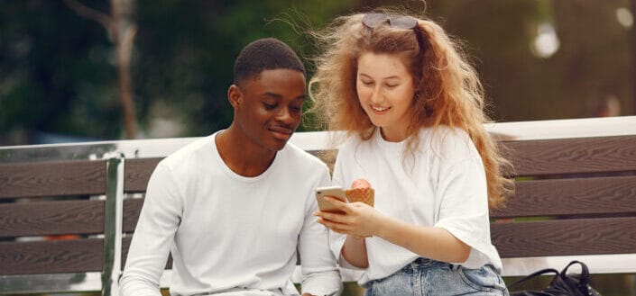 A man and a woman sitting on a bench