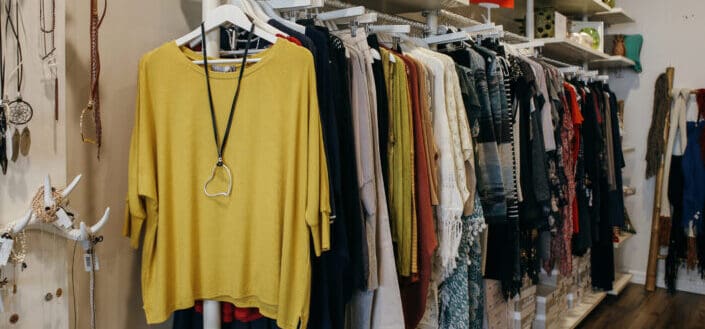 Apparels hanging on racks in a boutique