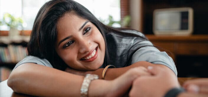 Happy indian woman holding hand of crop loving male