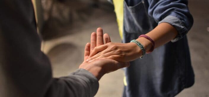 man and woman holding hands on street