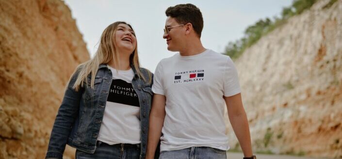 Man in white crew neck t shirt standing beside woman in blue denim jacket