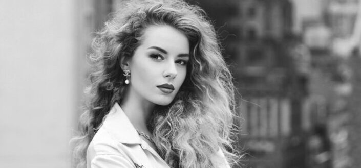 Curly Haired Woman in Long Sleeve Shirt