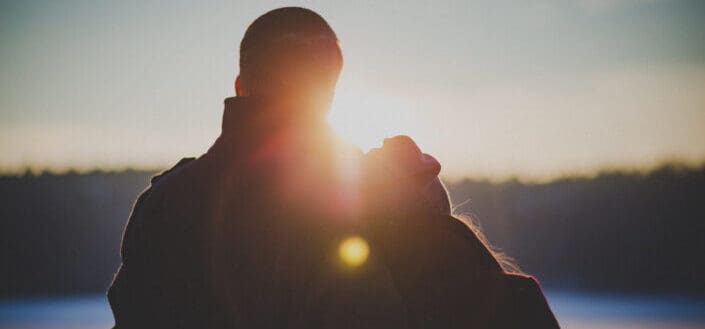 Silhouette of coupe standing during golden hour