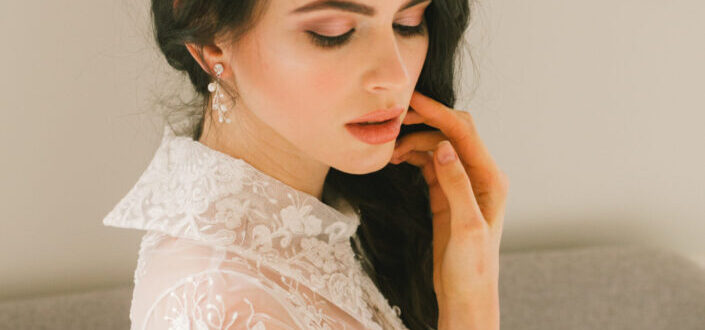 Young bride in diadem with delicate bouquet