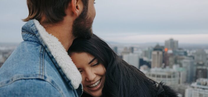 couple hugging while sight-seeing buildings