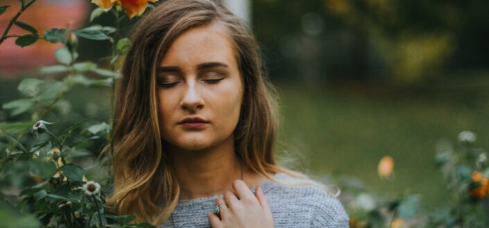woman lost in thought near garden 