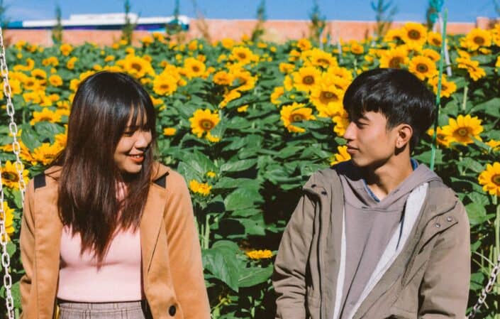 guy and girl on sunflower field