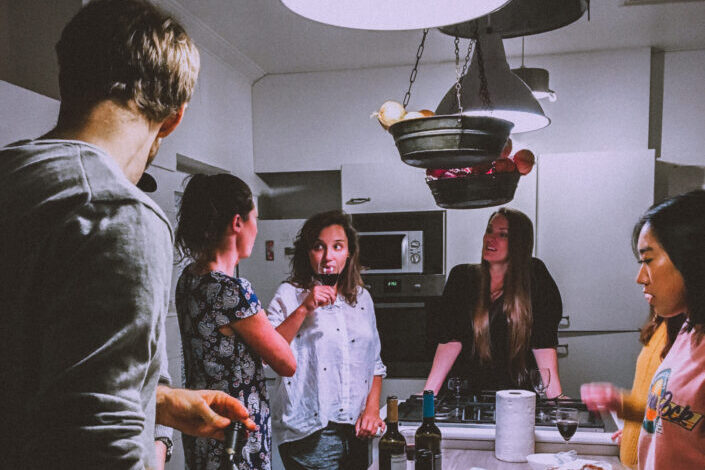 Men and Women Standing in Front of Dining Table