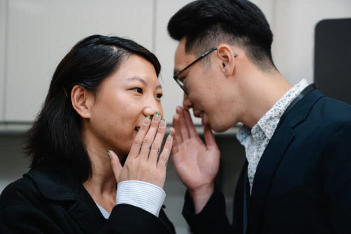 Colleagues Whispering to Each Other 