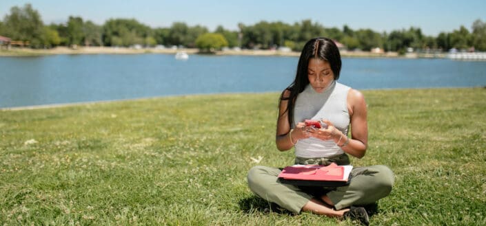 Woman in Tank Top Sitting on Grass