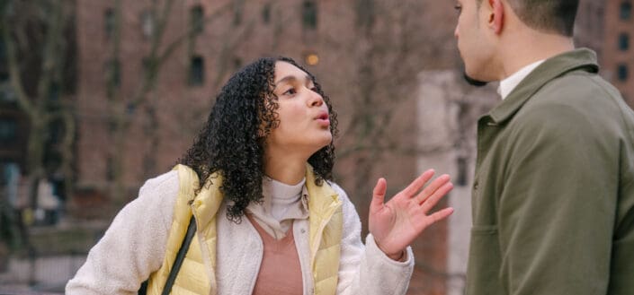 ethnic couple arguing on street