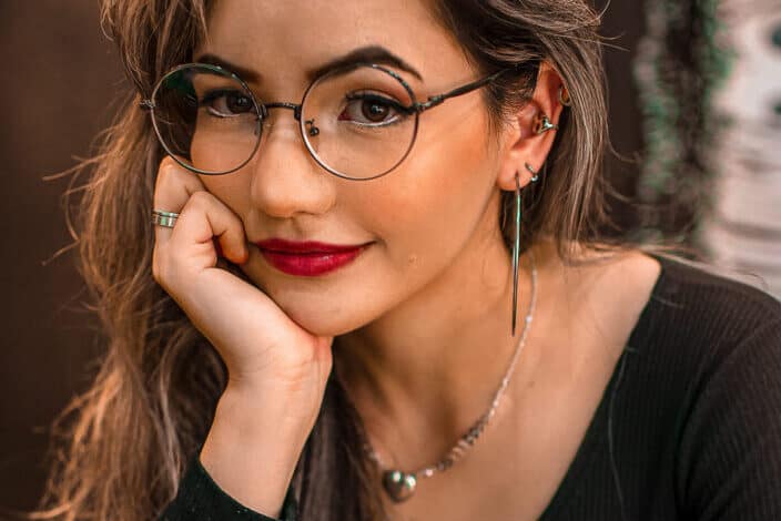 Beautiful woman with eyeglasses wearing red lipstick