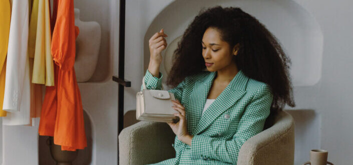Woman Inside a Room Looking at a Handbag