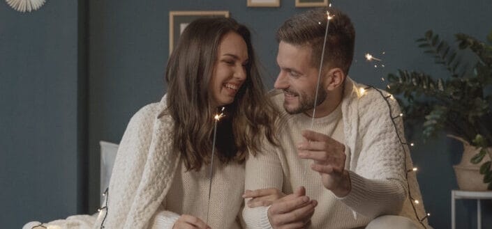 Couple Holding Burning Sparklers