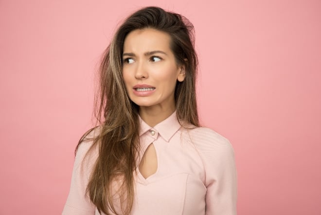 a woman with messy hair - bad haircut