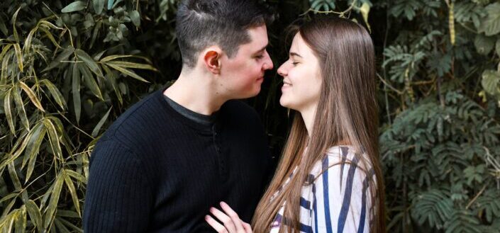 a man trying to kiss his girlfriend