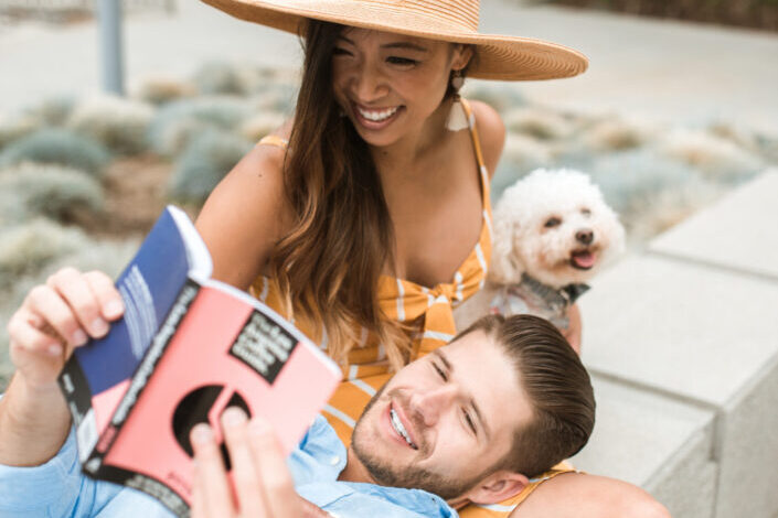 a happy couple on a date with their dog