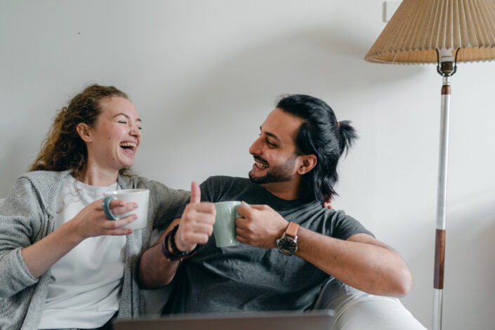 happy partner drinking coffee and showing like gesture