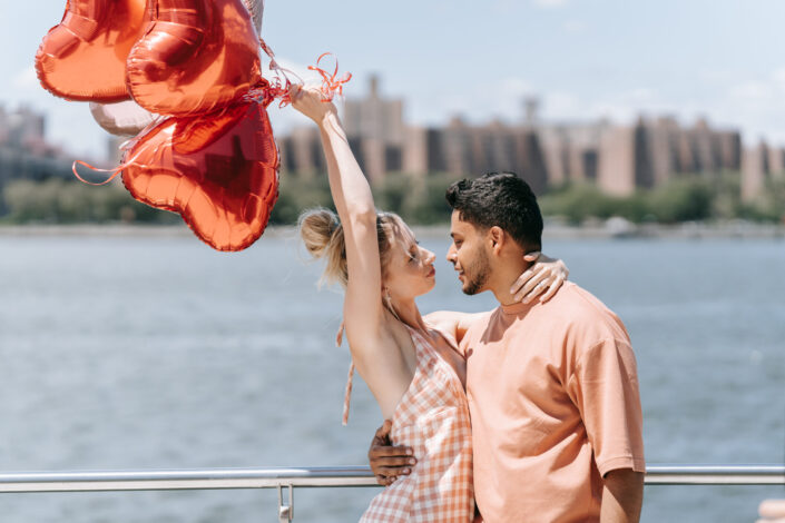 man in brown shirt hugging his girlfriend