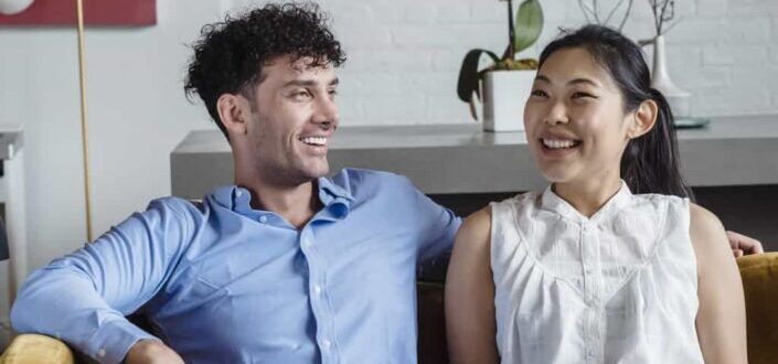 Smiling Couple Sitting on a Couch
