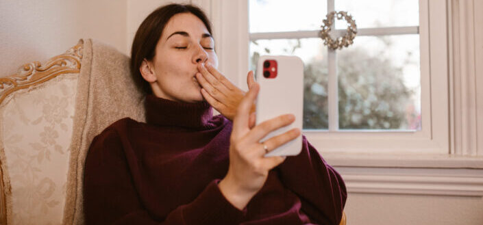 Woman sitting on chair while having a video call