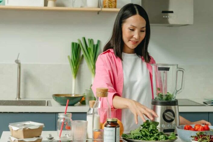 a woman making a smoothie