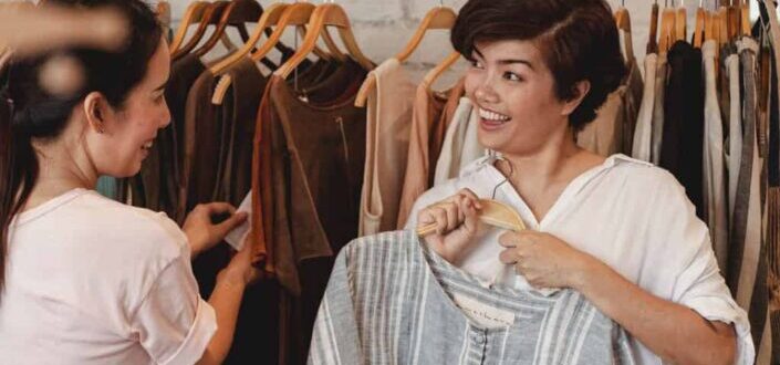Female Shoppers Interacting While Choosing Clothes in a Shop
